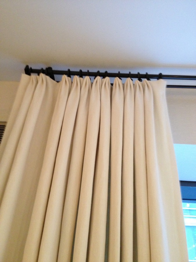 Pinch-pleat drapery on an iron rod